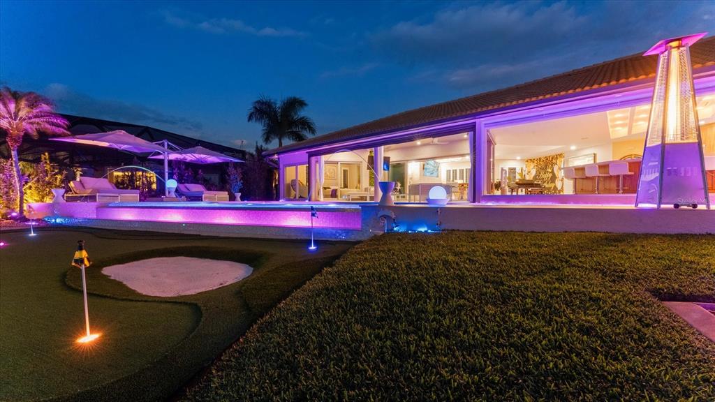 A single-story house with a tan tile roof, a paved driveway, and several palm trees — 2544 RIO LISBO COURT, PUNTA GORDA, FL