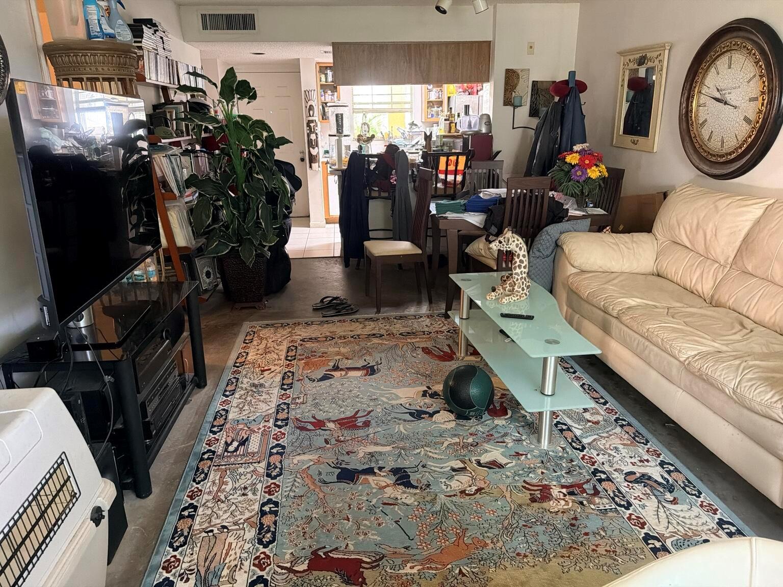 A living room features a patterned area rug, a glass coffee table, and a beige sofa — 6323 La Costa Drive # B, Boca Raton FL 33433, BOCA RATON, FL