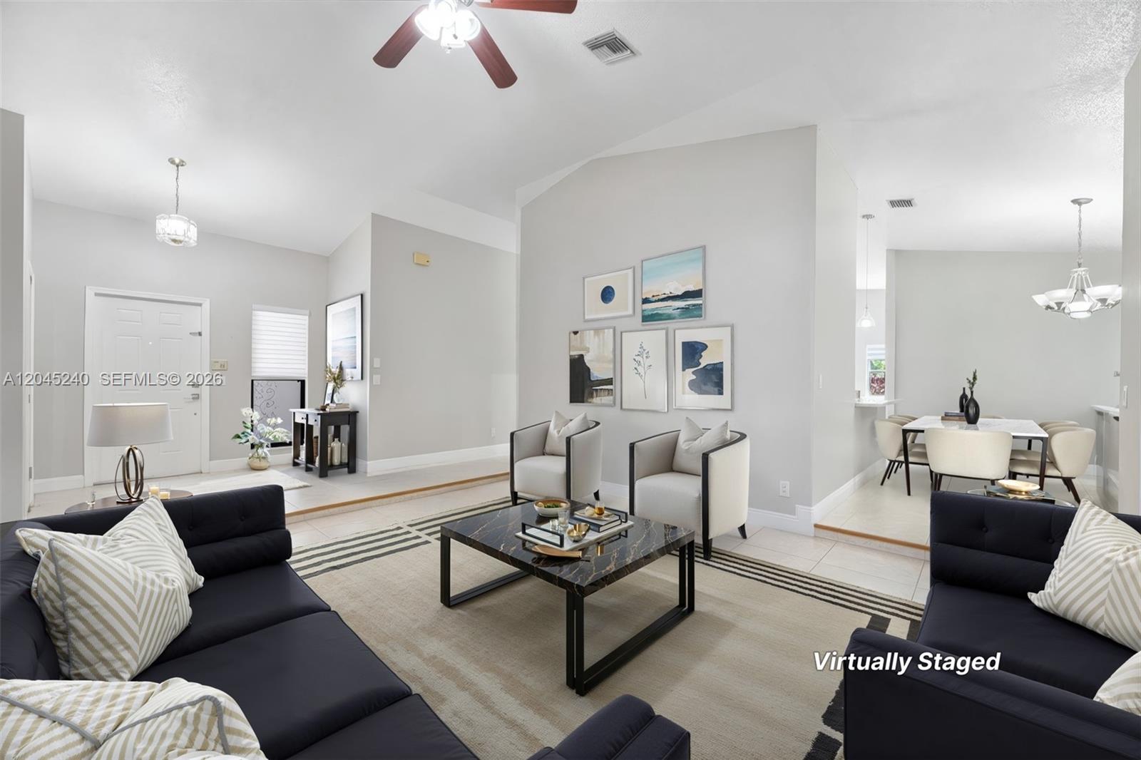 This virtually staged living room features a dark sofa, two armchairs, and a marble coffee table — 4870 Hawkes Bluff Ave, Davie FL 33331, DAVIE, FL