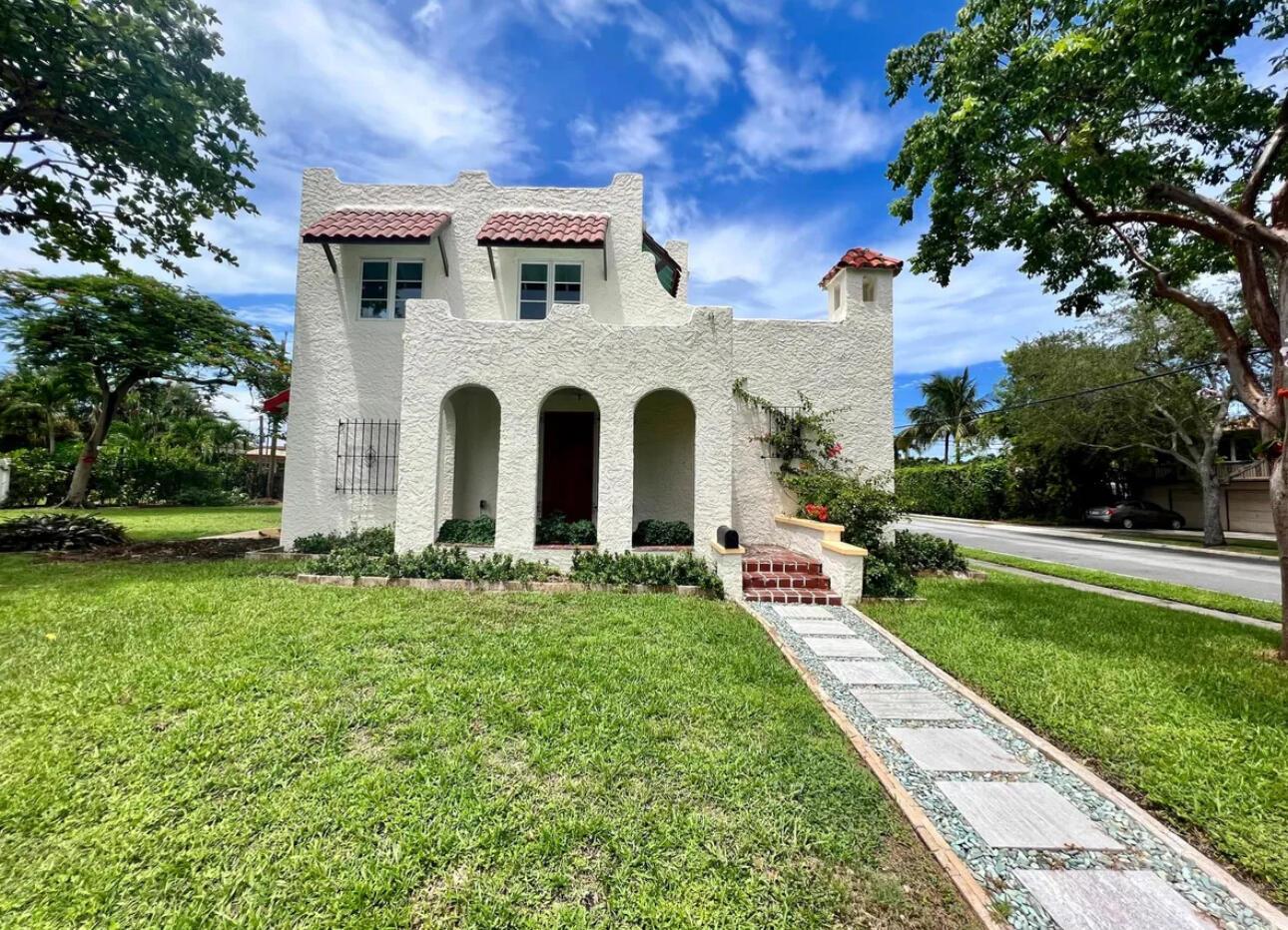 A two-story white stucco house with arched entryways and a red tile roof — 302 Fordham Drive, FL 33460, FL