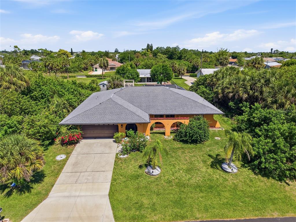 An aerial view shows a single-story house with a gray roof and orange exterior walls — 4248 KILPATRICK STREET, PORT CHARLOTTE, FL