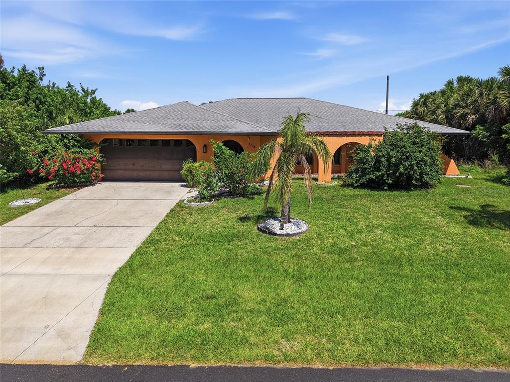 A single-story orange house with a gray roof, a concrete driveway, and a front lawn — 4248 KILPATRICK STREET, PORT CHARLOTTE, FL