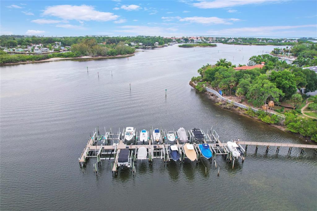 An aerial view shows a wooden boat dock with multiple moored boats in a waterway — Lot 6 MEYERS COVE DRIVE, TARPON SPRINGS, FL