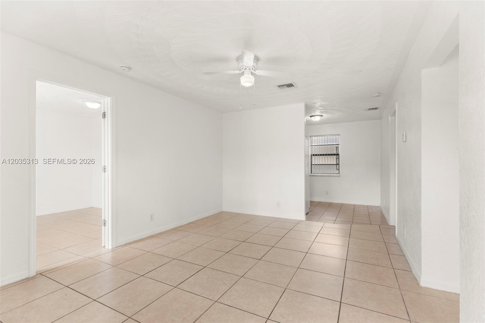 An interior view shows a room with white walls, a ceiling fan, and tiled flooring — 4120 SW 19th St # 2, West Park FL 33023, WEST PARK, FL