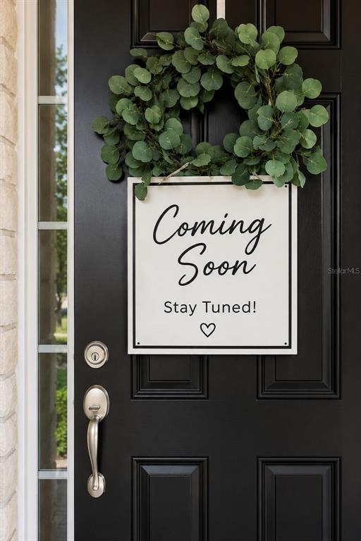 A black front door features a green wreath and a sign that says Coming Soon — 14409 MIRABELLE VISTA CIRCLE, TAMPA, FL