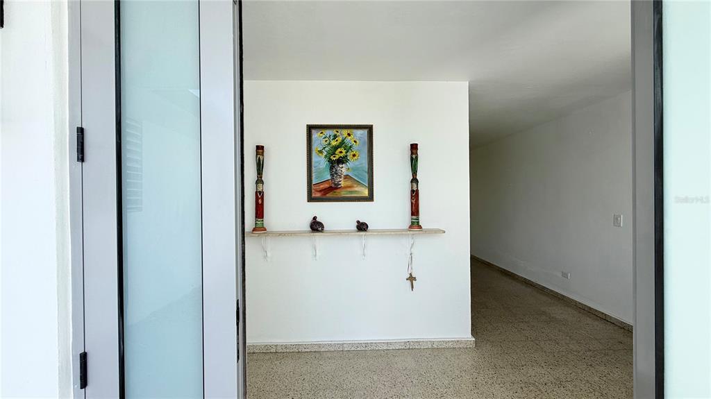 A view through a doorway shows a white wall with a shelf, artwork, and decor — 4-3 PASEO DE LA ALHAMBRA, GUAYNABO, PR