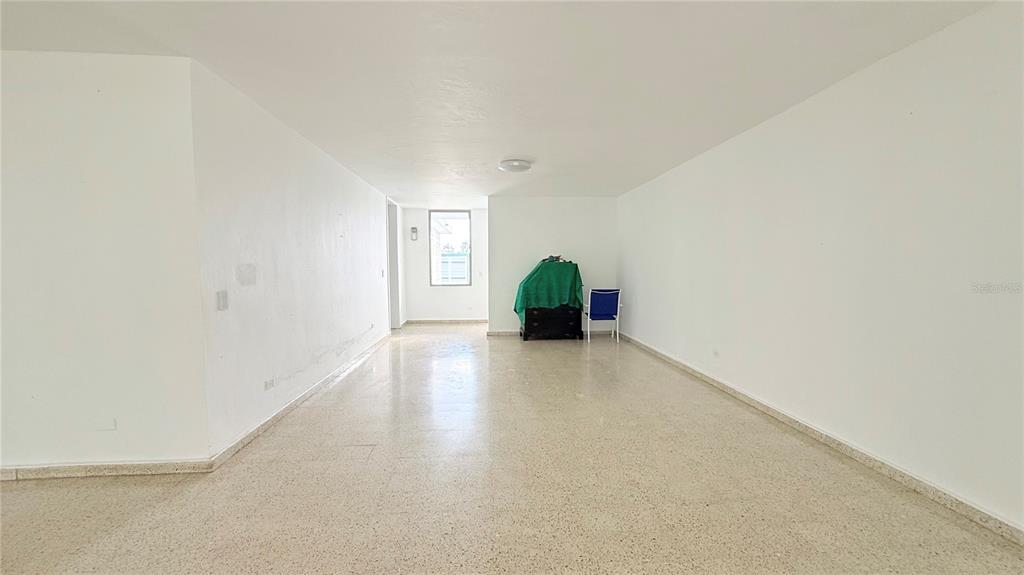 An empty, rectangular room with white walls, light-colored tile flooring, and a single window — 4-3 PASEO DE LA ALHAMBRA, GUAYNABO, PR