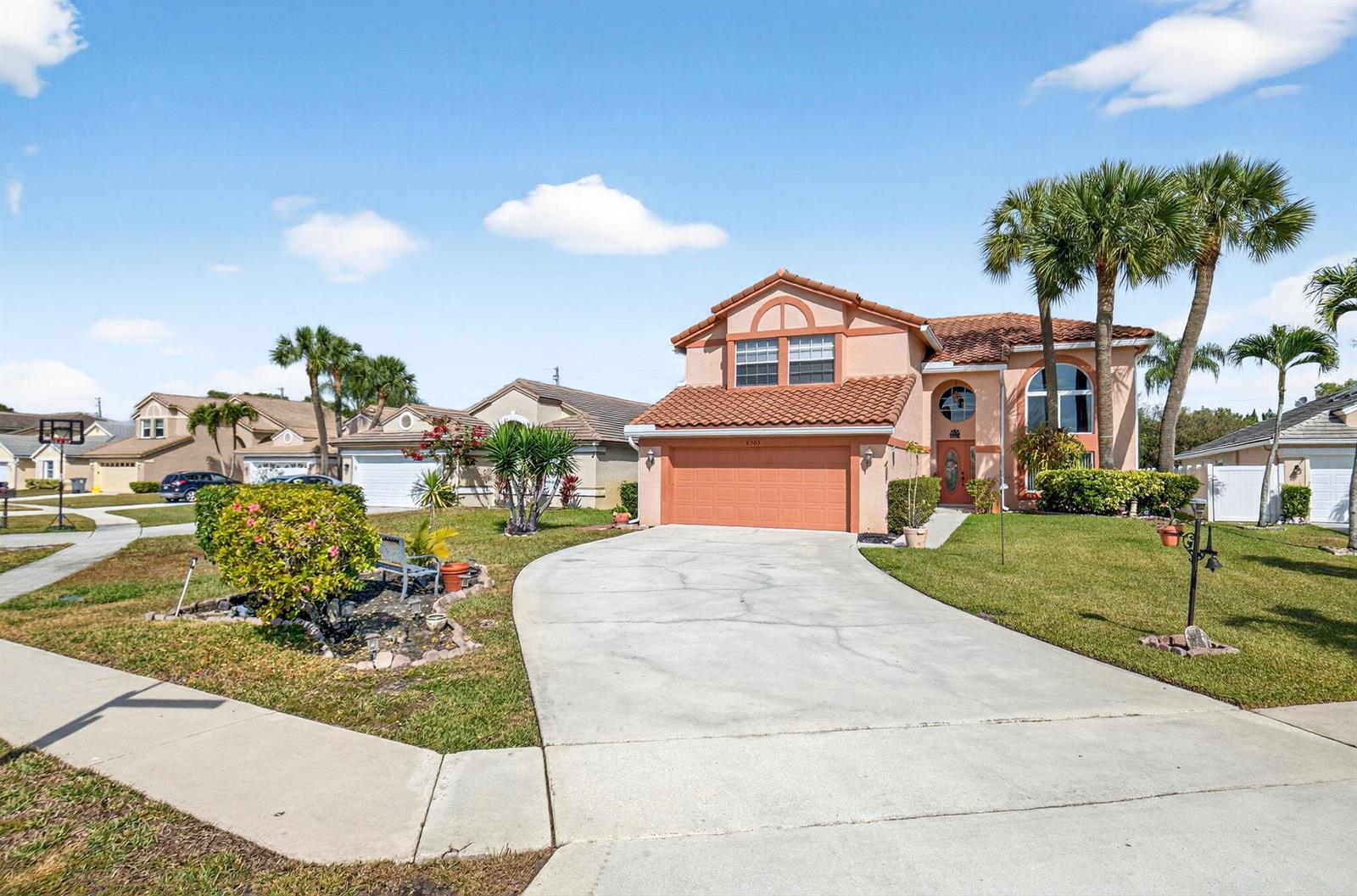 A two-story peach-colored house with a tile roof and a concrete driveway — 6205 Balmy Court, Boynton Beach FL 33472, BOYNTON BEACH, FL