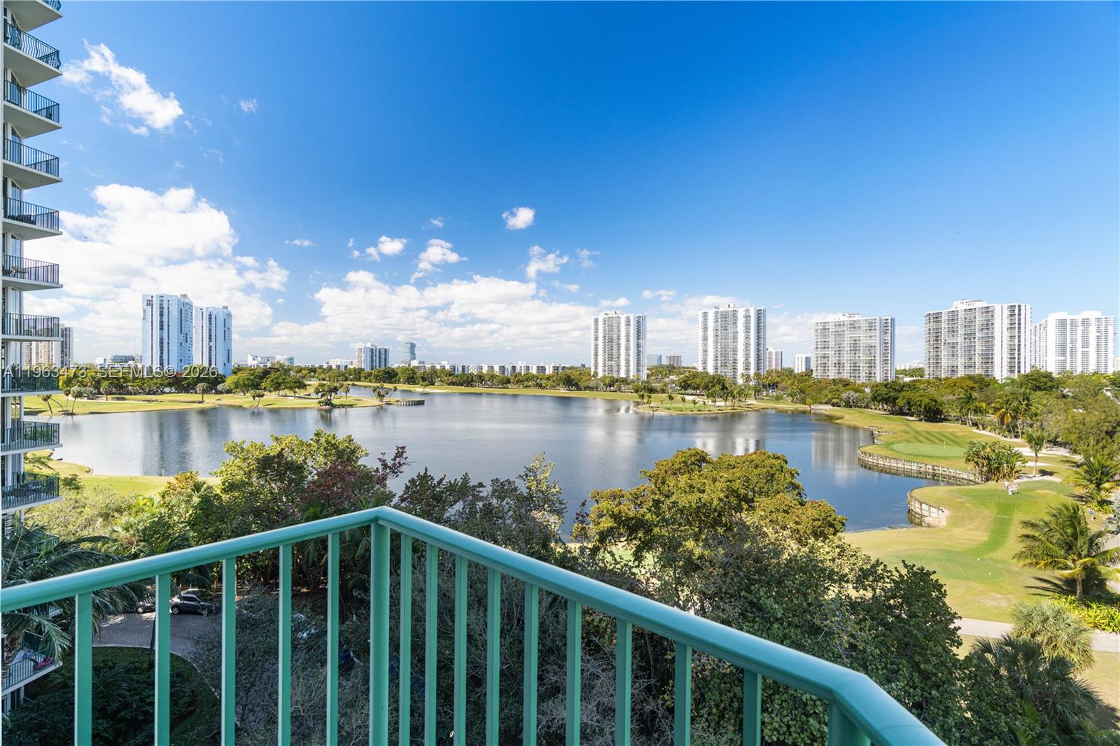 An aerial view shows a swimming pool surrounded by lounge chairs and palm trees — 20000 E Country Club Dr # 716, Aventura FL 33180, AVENTURA, FL