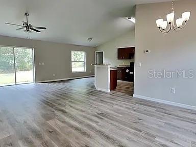 An open-concept living area features wood-look flooring, a ceiling fan, and a kitchen island — 3584 W BURGANDY DRIVE, CITRUS SPRINGS, FL