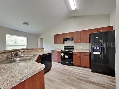 A kitchen features wood cabinets, black appliances, laminate countertops, and light-colored wood-look flooring — 3584 W BURGANDY DRIVE, CITRUS SPRINGS, FL
