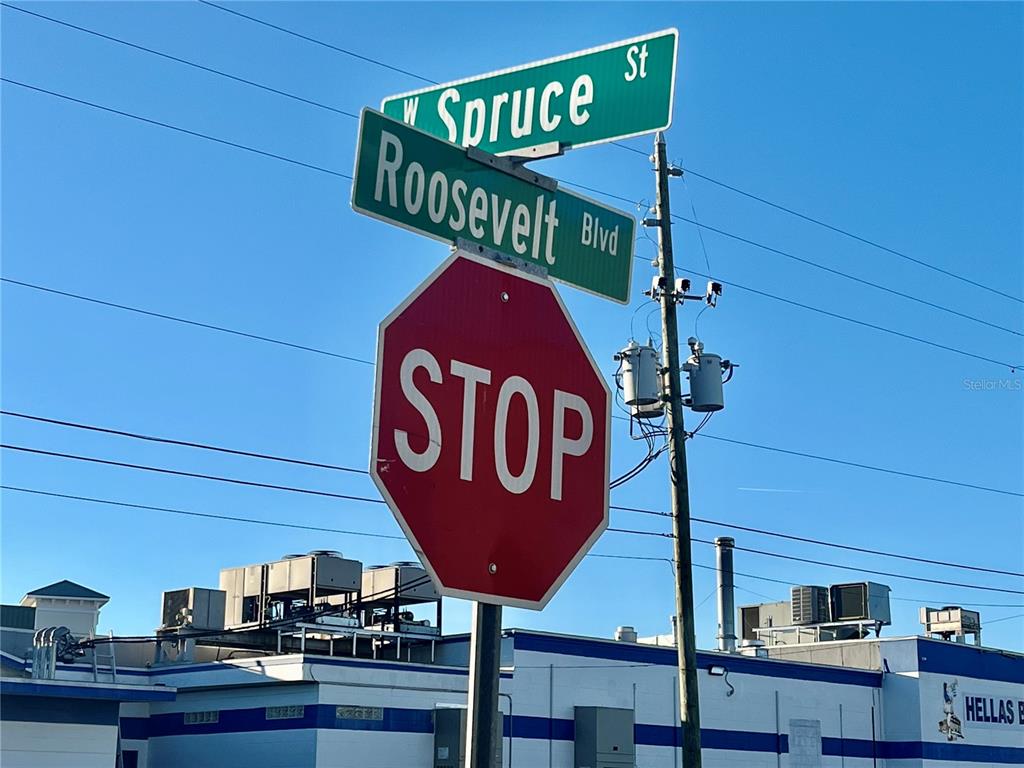 A stop sign stands at the intersection of W Spruce St and Roosevelt Blvd — W SPRUCE STREET, TARPON SPRINGS, FL