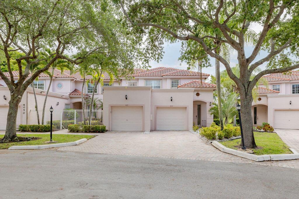 A two-story townhouse complex with beige stucco walls, tiled roofs, and attached garages — 8050 Aberdeen Drive # 202, Boynton Beach FL 33472, BOYNTON BEACH, FL