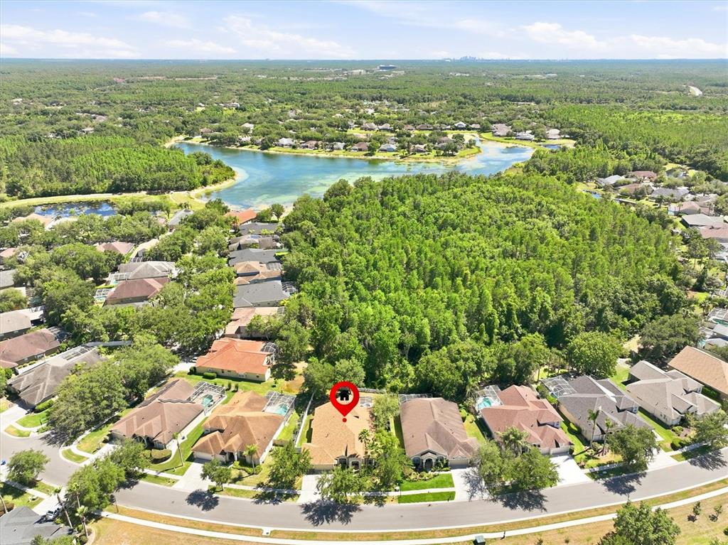 An aerial view shows a suburban house with a red location pin in a neighborhood — 8331 GOLDEN PRAIRIE DRIVE, TAMPA, FL