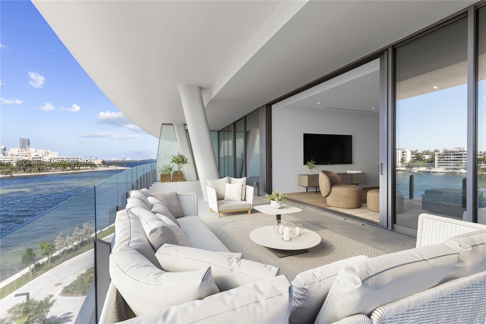 This rendering shows a modern balcony with outdoor seating overlooking a waterfront view — 5 Grove Isle Dr # S401, Miami FL 33133, MIAMI, FL