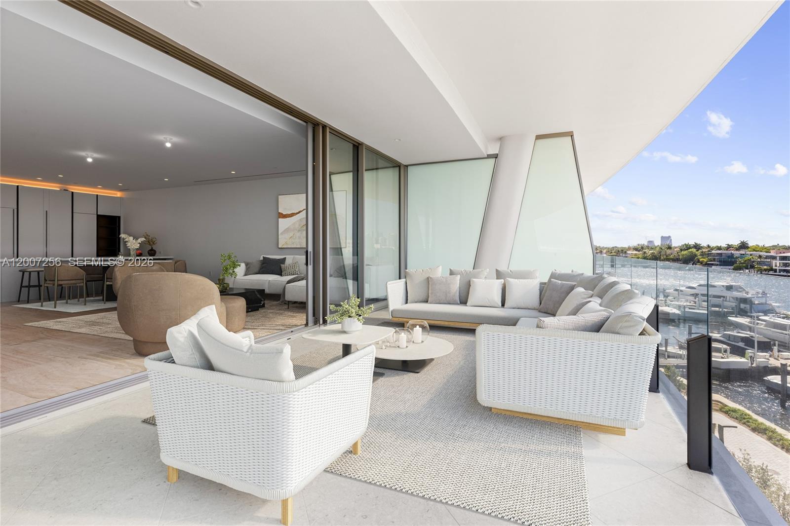 A spacious outdoor balcony features modern wicker furniture overlooking a marina and waterway — 5 Grove Isle Dr # S401, Miami FL 33133, MIAMI, FL
