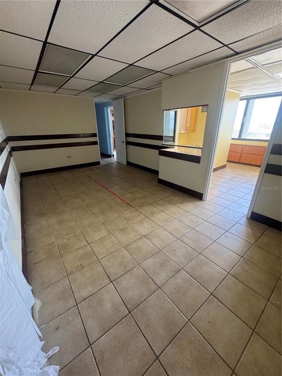 An interior office space features tiled floors, a drop ceiling, and a service window opening — Cond Torre San Pablo SANTA CRUZ UNIT 805, BAYAMON, PR