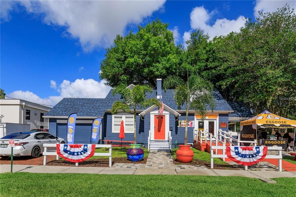 A blue house with a red front door and an outdoor food stand in front — 300 S EOLA DRIVE, ORLANDO, FL