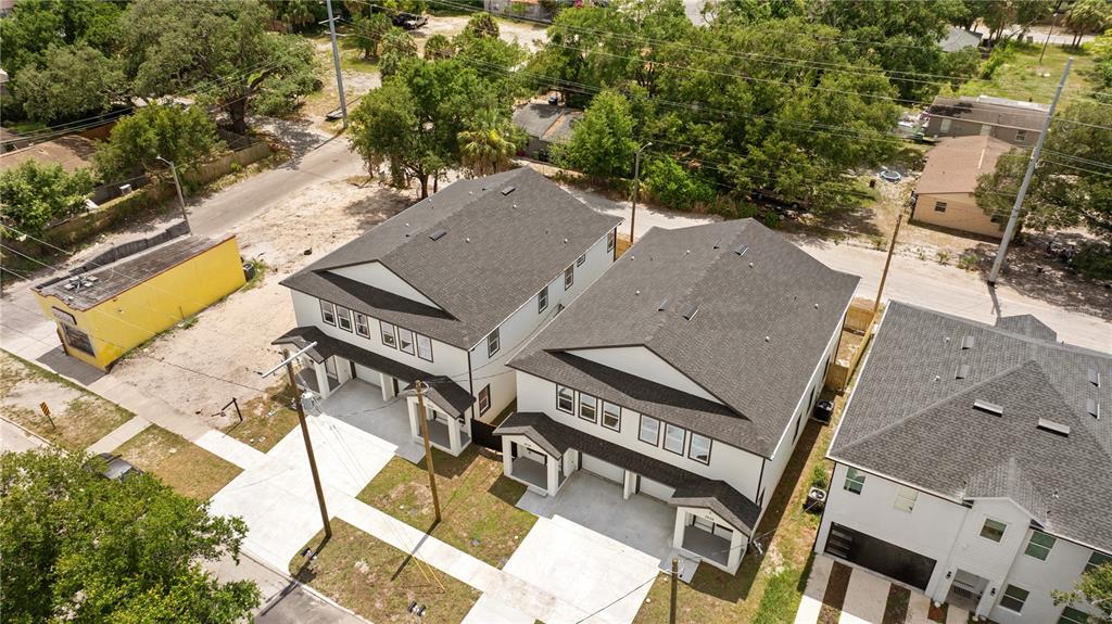 An aerial view shows three modern, multi-story residential buildings with dark roofs and white siding — 2806 N 29TH STREET UNIT 2, TAMPA, FL