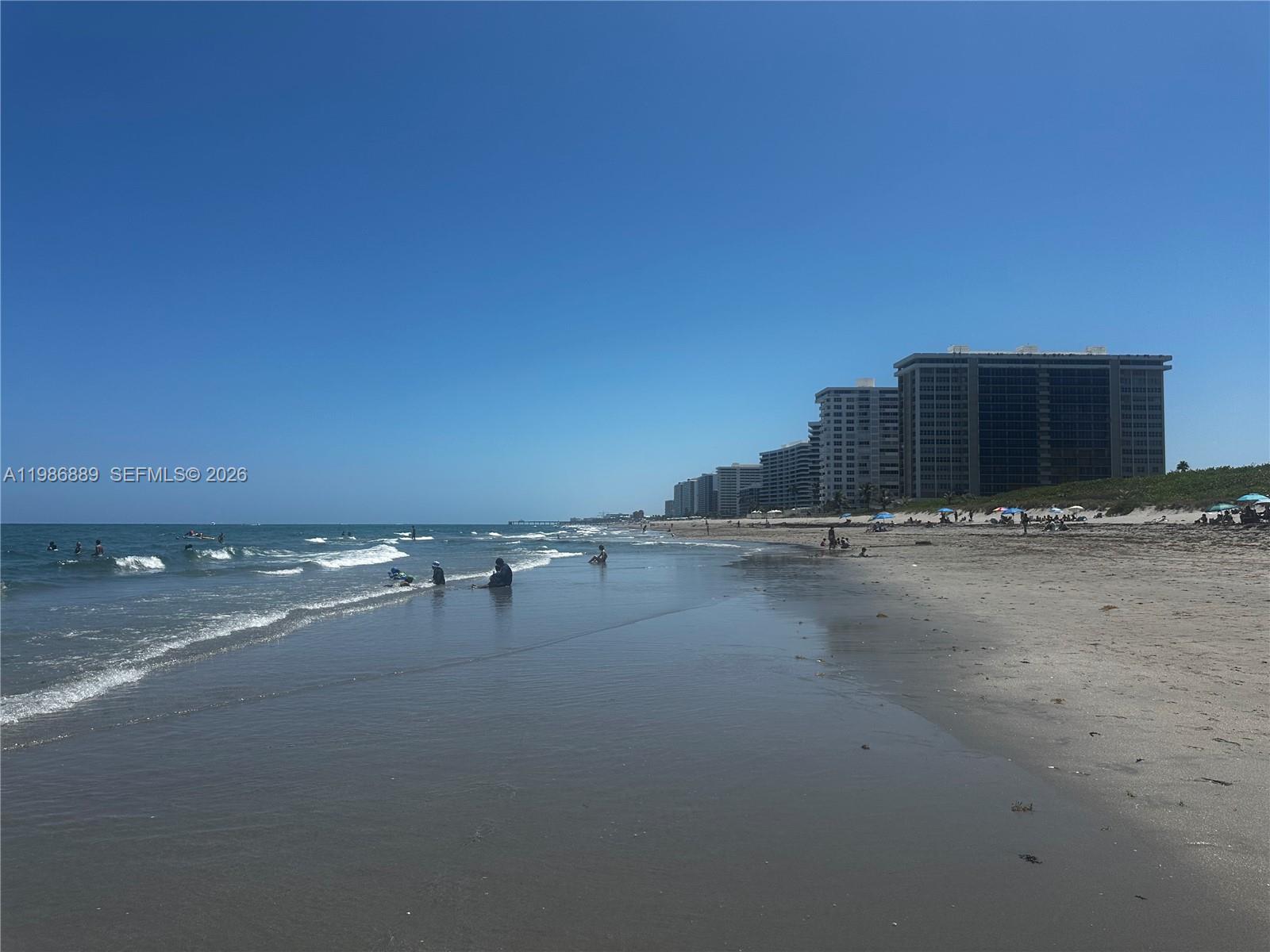 A sandy beach stretches along the ocean with high-rise buildings in the background — 2851 S Ocean Boulevard # V, Boca Raton FL 33432, BOCA RATON, FL