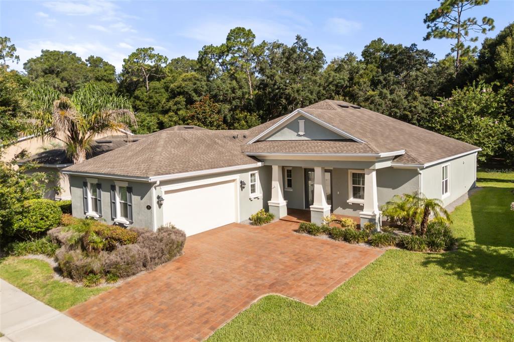 A single-story house with a paved driveway, a two-car garage, and a covered front porch — 171 BIRCHMONT DRIVE, DELAND, FL