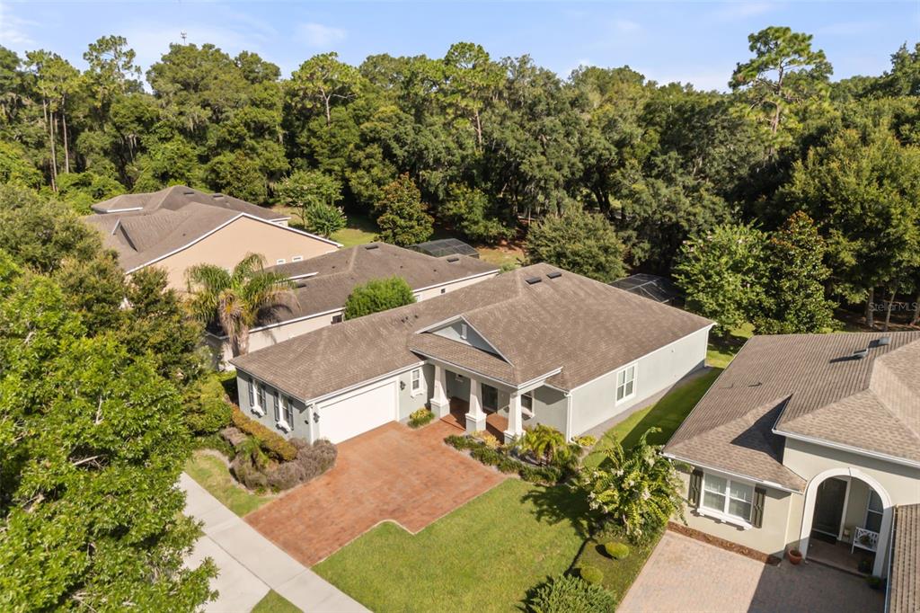 An aerial view shows a suburban house with a brown roof and paved driveway — 171 BIRCHMONT DRIVE, DELAND, FL
