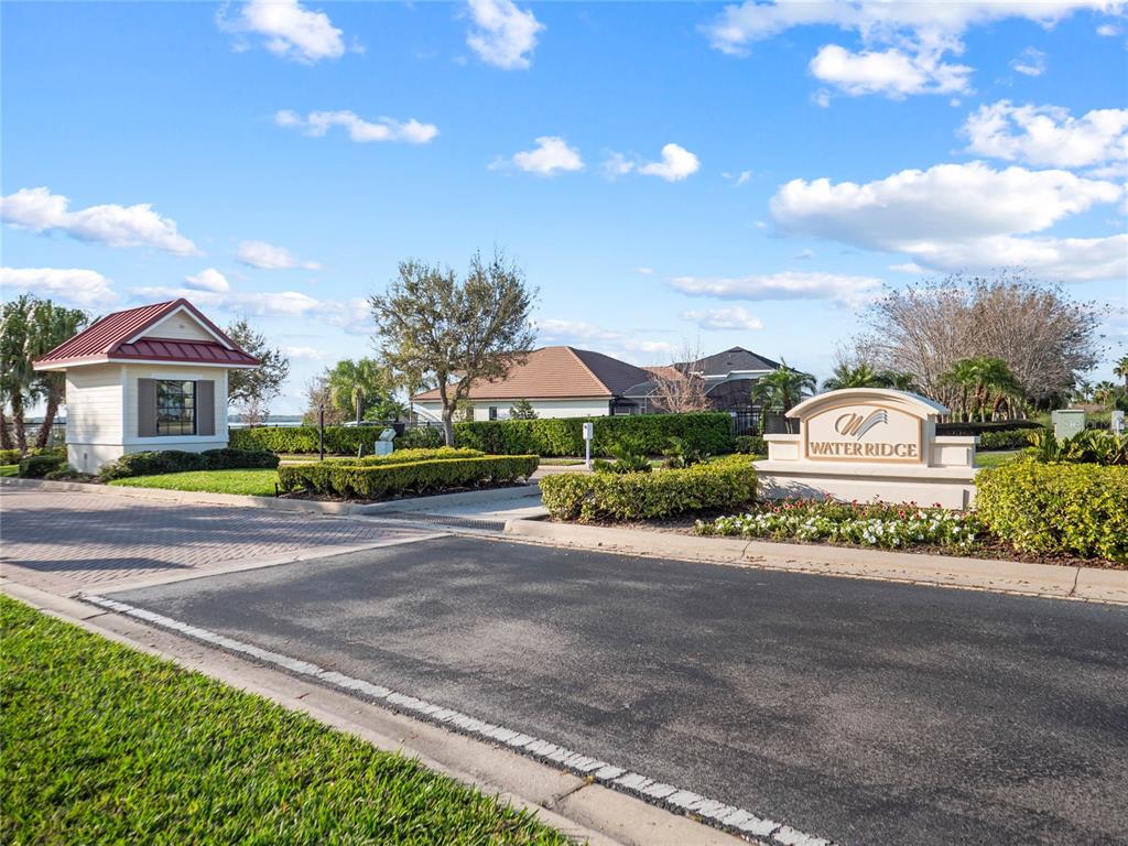 A beige monument sign for Water Ridge stands in front of trees and flowers — 535 ADAMS VIEW LANE, AUBURNDALE, FL
