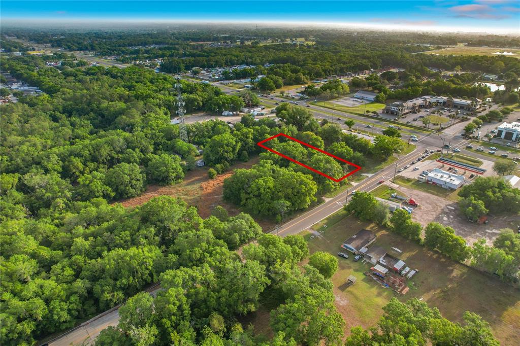 An aerial view shows a rectangular plot of land outlined in red near a road — 1225 DUFF ROAD, LAKELAND, FL