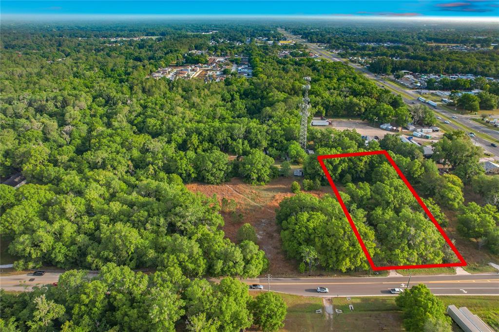 An aerial view shows a rectangular plot of land outlined in red near a road — 1225 DUFF ROAD, LAKELAND, FL