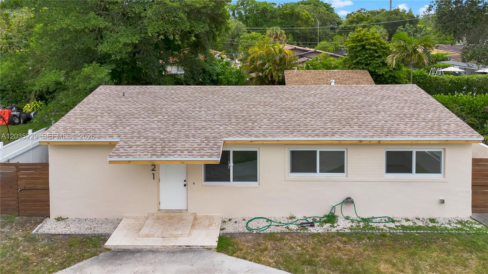 A single-story house with a beige exterior, a shingled roof, and a white front door — 321 NW 56th Av, Miami FL 33126, MIAMI, FL