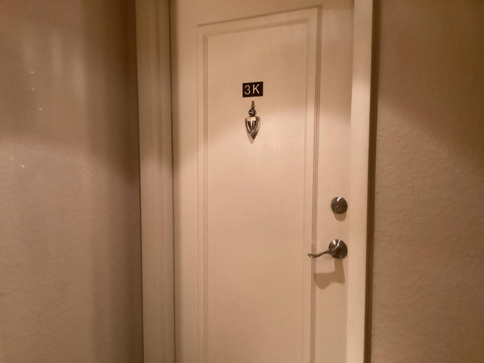 A white interior door features a door knocker and a sign labeled 3K — 1000 Spanish River Road # 3k, Boca Raton FL 33432, BOCA RATON, FL