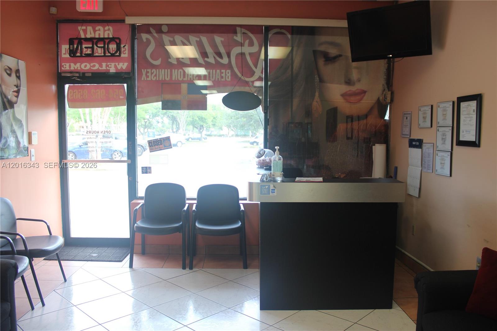 A reception area features a dark desk, two waiting chairs, and a large window display — 6647 Taft St, Hollywood FL 33024, HOLLYWOOD, FL