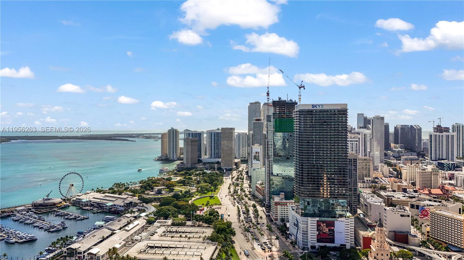 An aerial view shows a coastal city skyline with high-rise buildings, a marina, and parkland — 398 NE 5th St # 1408, Miami FL 33132, MIAMI, FL