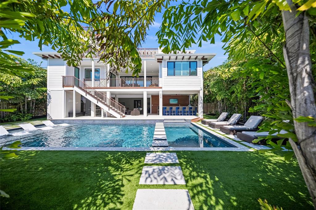 A two-story house with a swimming pool, outdoor bar, and a staircase leading to a balcony — 209 WILLOW AVENUE, ANNA MARIA, FL