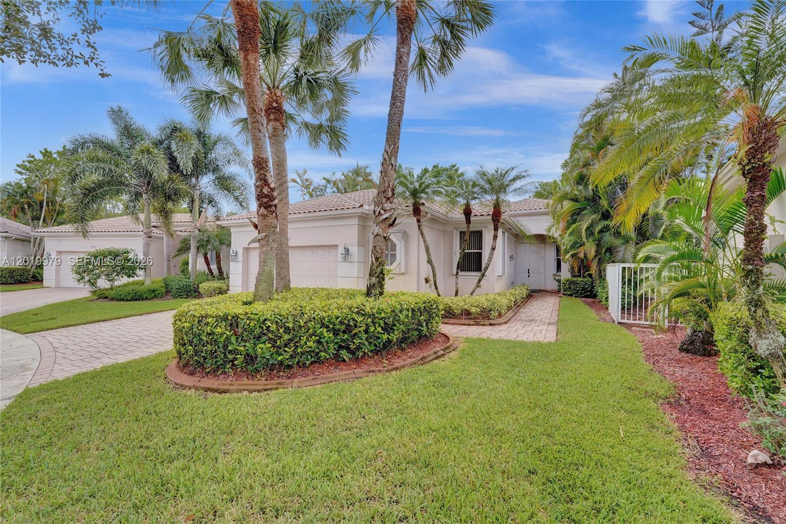 A single-story house with a paved driveway, palm trees, and a landscaped front yard — 2525 Bay Pointe Ct, Weston FL 33327, WESTON, FL