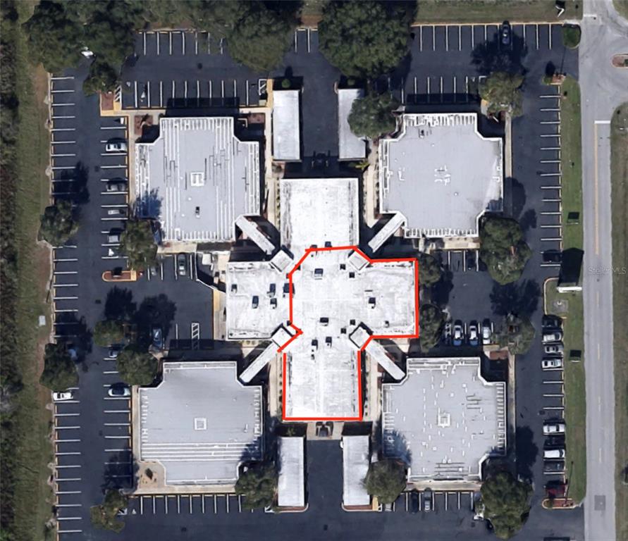 An aerial view shows a commercial building complex with a highlighted central roof section — 6801 US 27 HIGHWAY N UNIT E-5, 6, & 7, SEBRING, FL