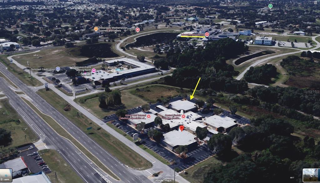 An aerial view of a commercial office complex with a yellow arrow pointing toward it — 6801 US 27 HIGHWAY N UNIT E-5, 6, & 7, SEBRING, FL
