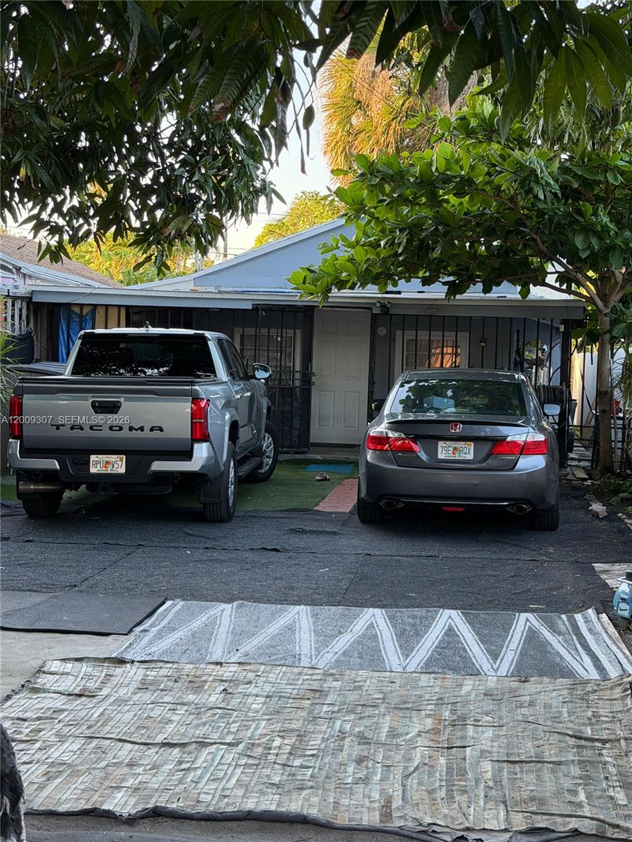 A gray pickup truck and a gray sedan are parked in front of a house — 1111 NW 26th St, Miami FL 33127, MIAMI, FL