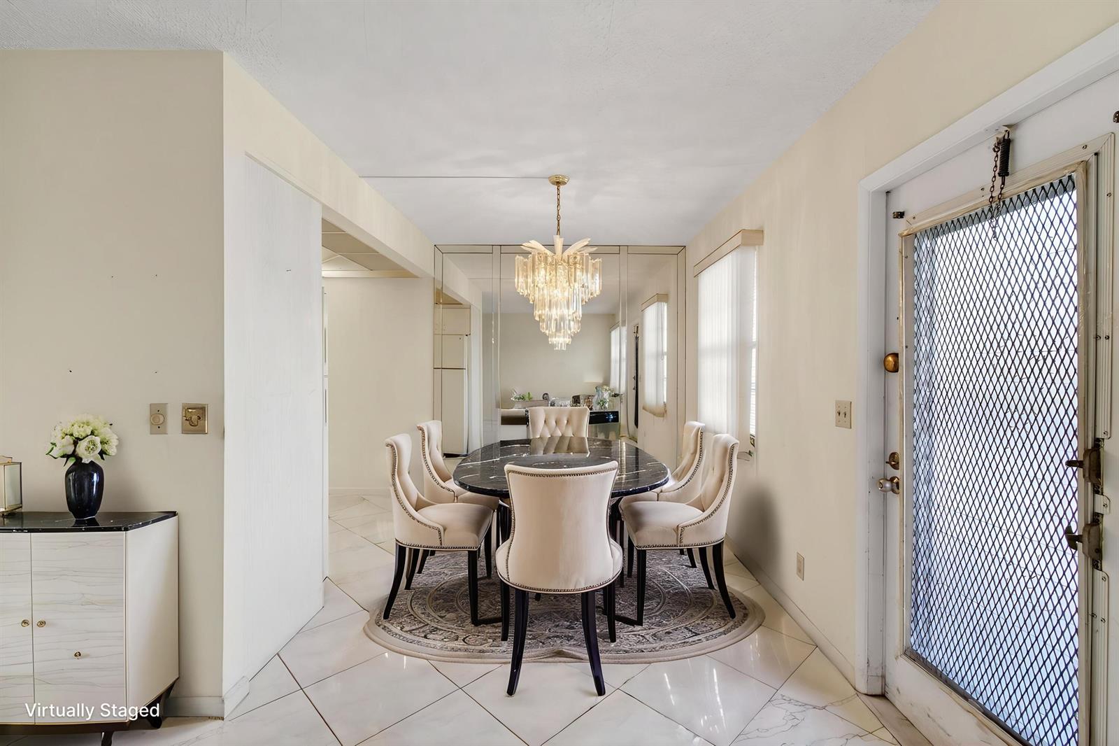 A dining room features a marble table, upholstered chairs, a crystal chandelier, and mirrored walls — 3044 Lincoln, Boca Raton FL 33434, BOCA RATON, FL