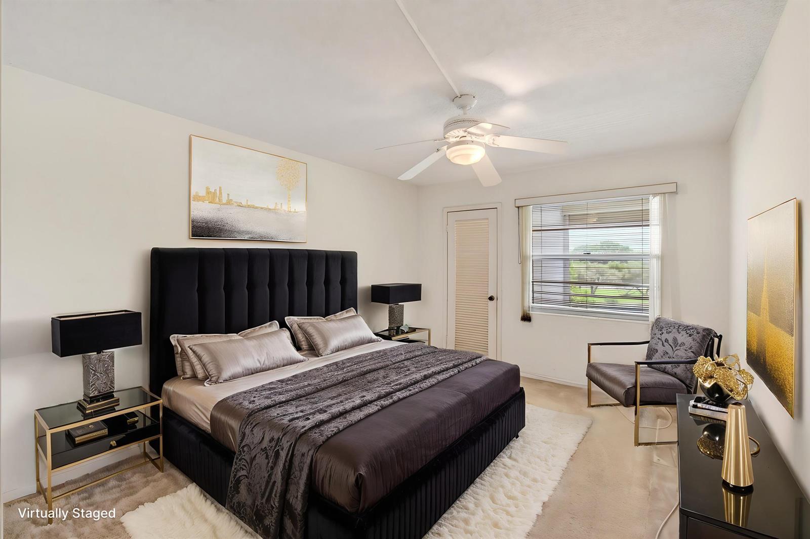A bedroom with a black tufted bed, white rug, and a window overlooking green space — 3044 Lincoln, Boca Raton FL 33434, BOCA RATON, FL