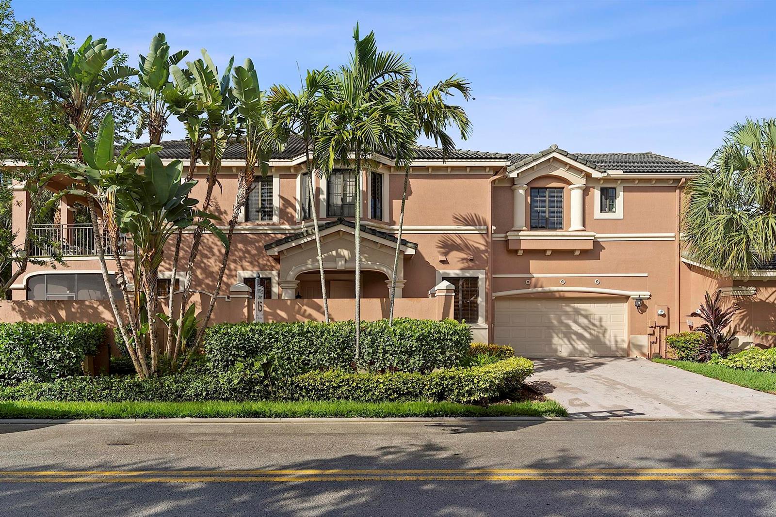 A two-story stucco house with a tile roof, palm trees, and a two-car garage — 2742 Kinsington Circle, Weston FL 33332, WESTON, FL