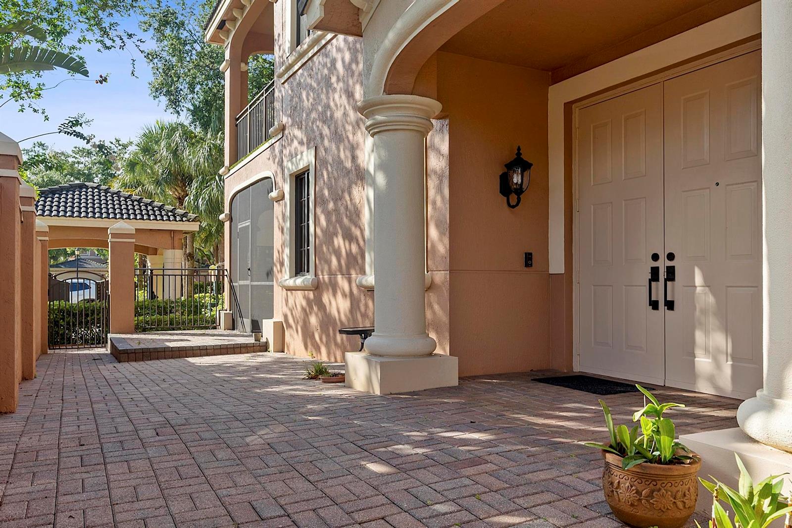 A paved entryway leads to a double door entrance with a large decorative column — 2742 Kinsington Circle, Weston FL 33332, WESTON, FL