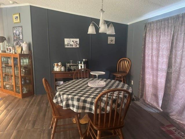 A dining area features a round table with a checkered cloth, wood flooring, and sliding doors — 4650 SW 36 STREET, OCALA, FL