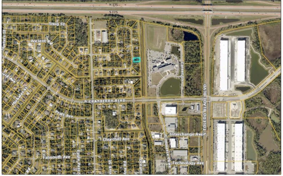 This is an aerial map showing a residential lot highlighted in blue within a neighborhood — Lot 24 LARAMIE CIRCLE, NORTH PORT, FL