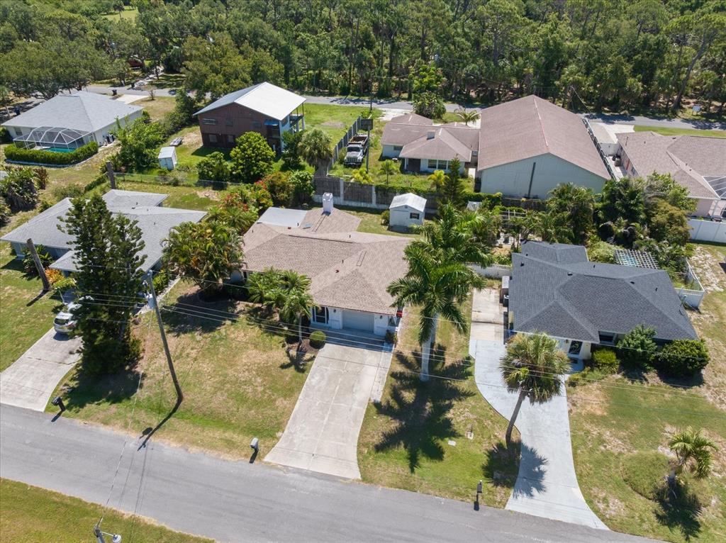 An aerial view shows several suburban houses with driveways and palm trees in a neighborhood — 1236 GAYLE AVE, NOKOMIS, FL