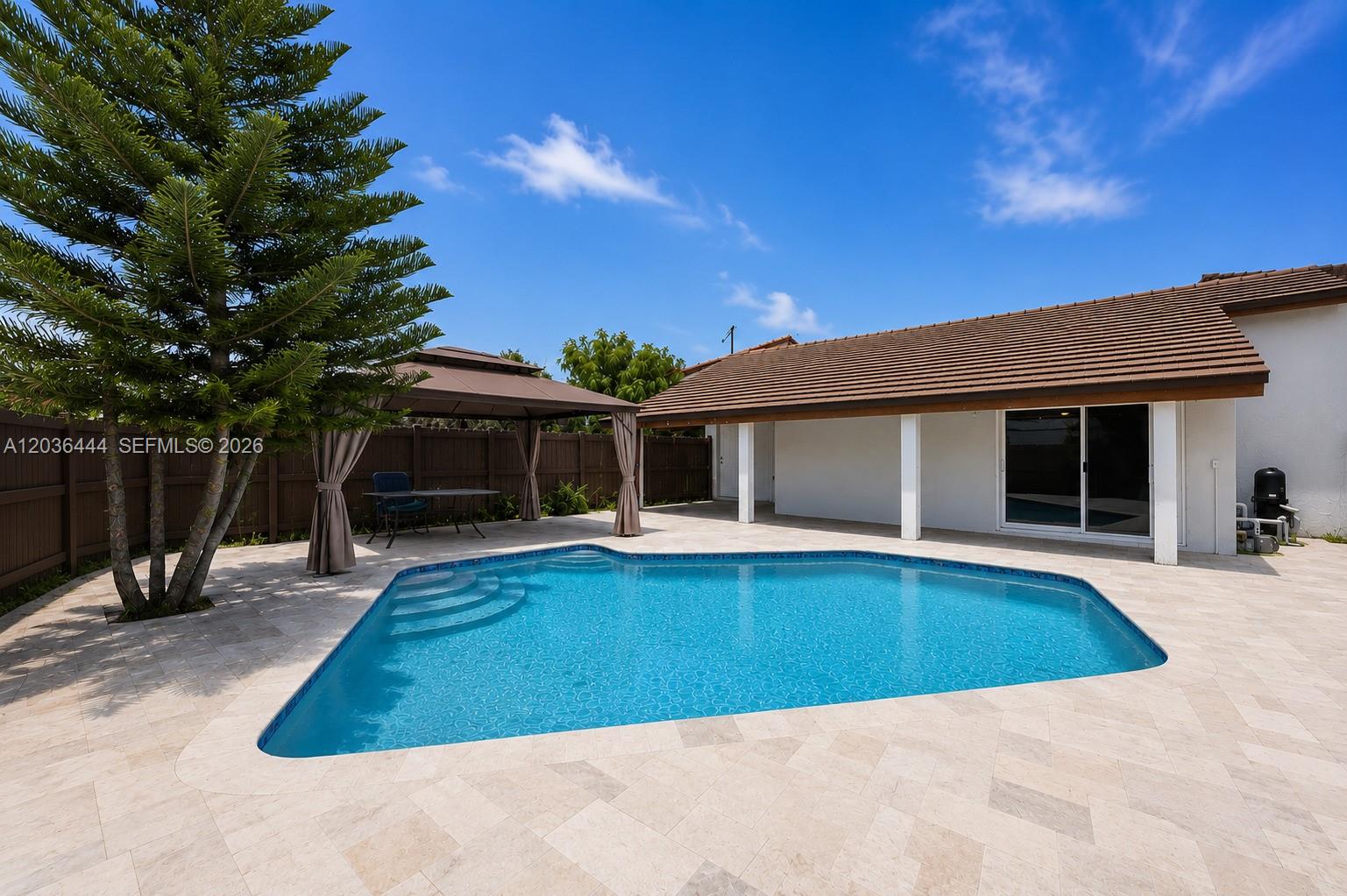 A backyard features a swimming pool, a gazebo, and a patio next to a house — 13263 SW 9th Ter, Miami FL 33184, MIAMI, FL