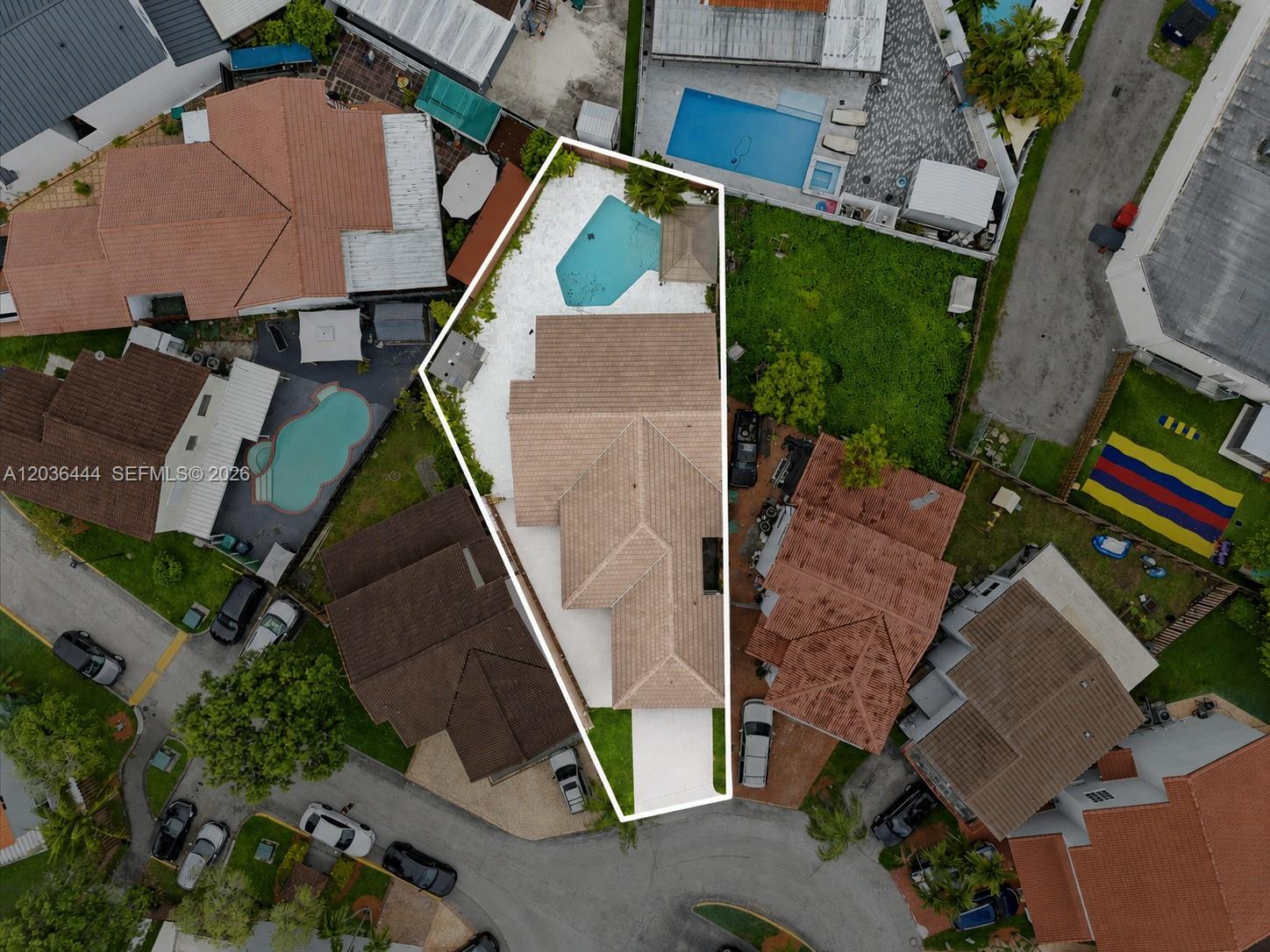 An aerial view shows a residential property with a swimming pool and a tiled roof — 13263 SW 9th Ter, Miami FL 33184, MIAMI, FL
