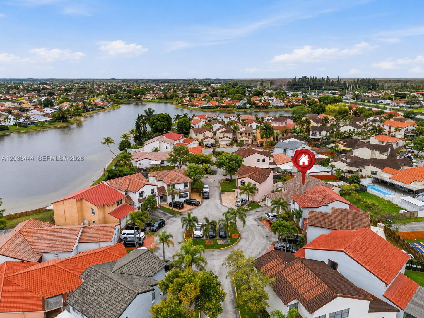 An aerial view shows a suburban neighborhood with houses featuring red tile roofs — 13263 SW 9th Ter, Miami FL 33184, MIAMI, FL