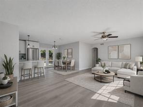 An open-concept living and dining area with light wood floors, white walls, and modern furniture — 2064 Atlantic Boulevard, Vero Beach FL 32960, VERO BEACH, FL
