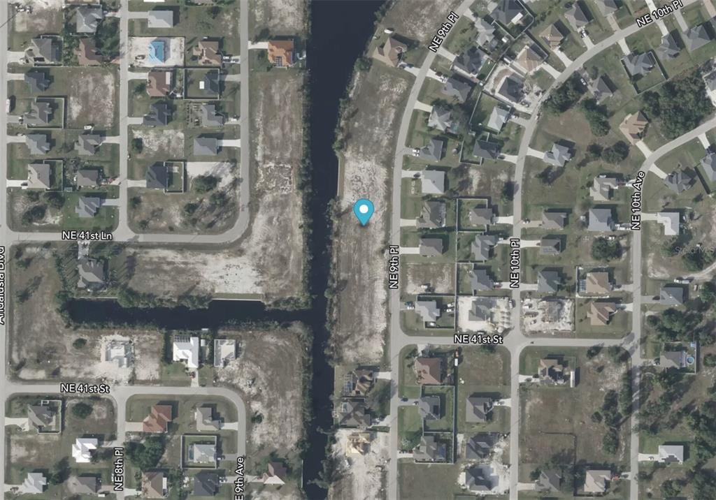 This is an aerial map view of a vacant residential lot along a canal — 4112 NE 9TH PLACE, CAPE CORAL, FL